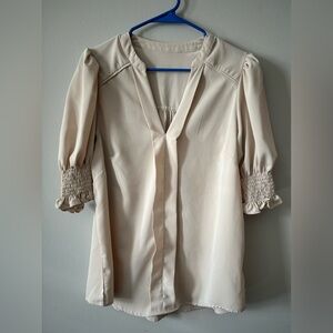 Large tan v-neck blouse with puff ruffle sleeves